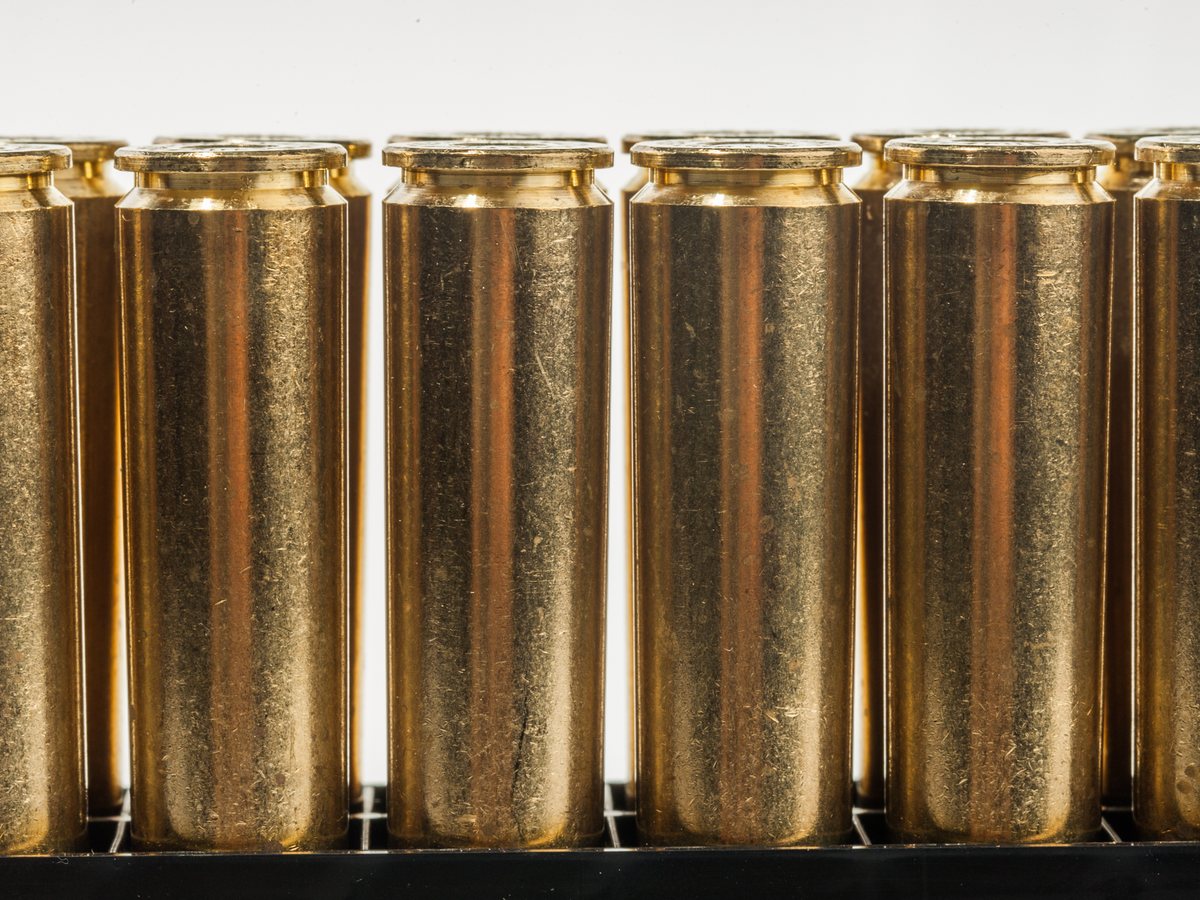 Rows of brass cases standing on end, sorted and ready to load