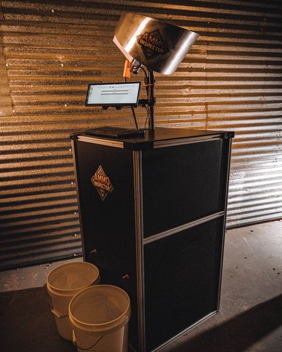 AccuWeigh 360 weight inspection system with collator feed on a black cabinet